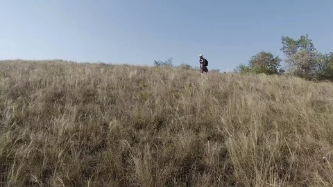 The girl rises up the slope Stock Footage 80477142