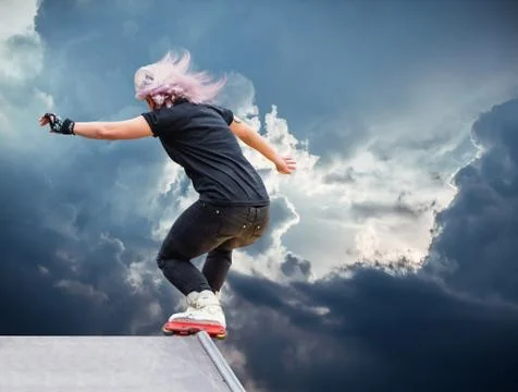 Girl roller performs a trick Stock Photos