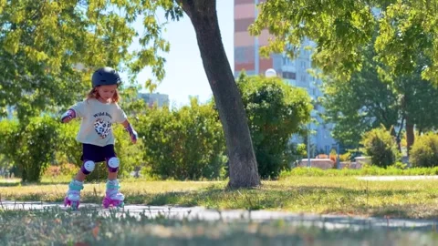 Girl roller skating during an active outdoor walk Stock Footage 344605640