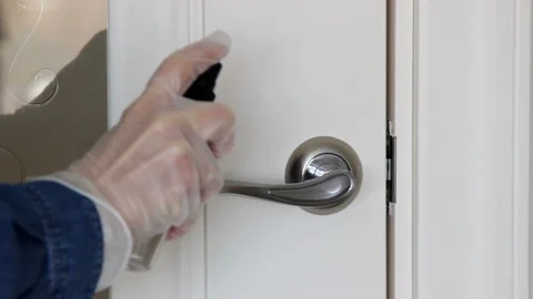 Girl In Rubber Gloves Using Close And Sanitizer Spray for Disinfect Door Handle Stock Footage 129293216