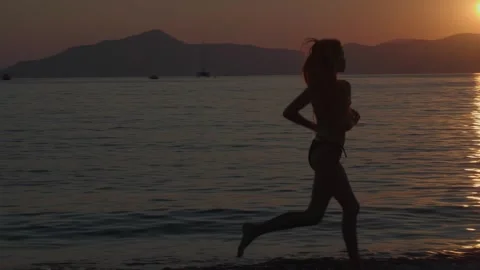 Girl running on the beach Stock Footage 246498473