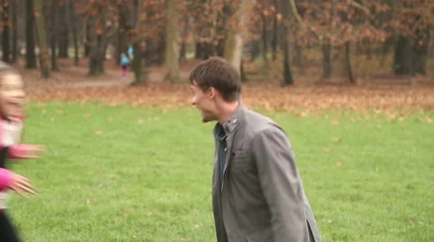 Girl running into father's arms in park Stock Footage 59554128