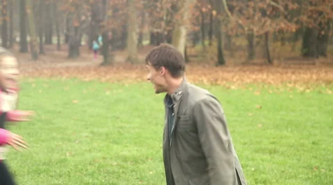 Girl running into father's arms in park Stock Footage 59554135