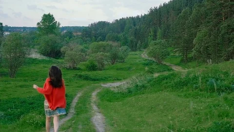 Girl running in green field Stock Footage