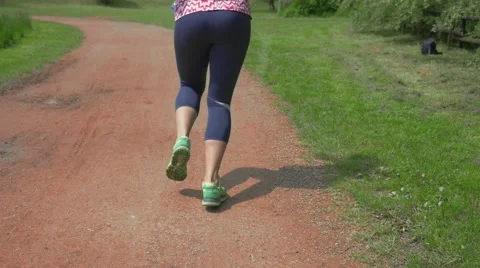Girl running in the park with bottled water. Slow motion. Stock Footage 63196341
