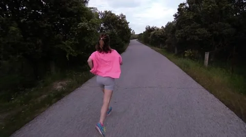 Girl running in a road Stock Footage 63394982