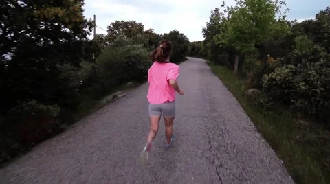 Girl running on a road Stock Footage 63395051