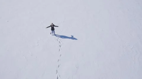 Girl running on the snow Stock Footage 58744344