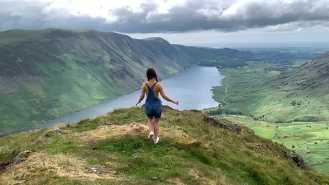 A girl running on top of a cliff Stock Footage