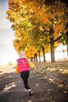 Girl Running Under Fall Trees Stock Photos