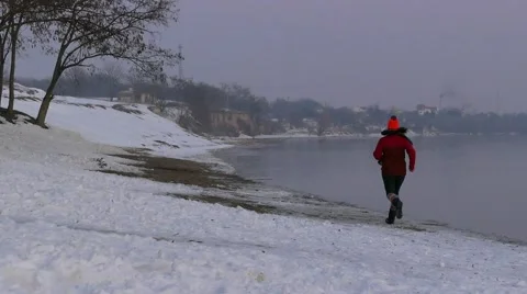 Girl runs along the bank of the Danube in winter. Stock Footage 59795193