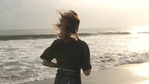Girl runs near the ocean Stock Footage