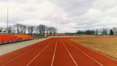 Girl runs on a treadmill at the stadium. Training young sportswoman. Start Stock Footage 105221237