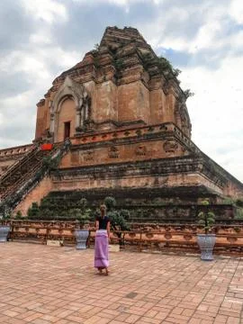 Girl in sarong standing in front of a temple Stock Photos