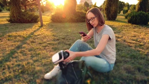 Girl scanning qr code on her virtual reality glasses with smartphone. Stock Footage 91305385