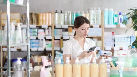 Girl scans code on package of ointment to check the expiration date Stock Footage 325766023