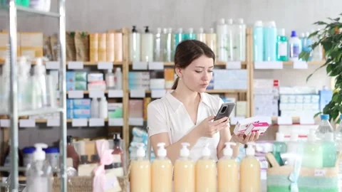 Girl scans code on package of paracetamol pills to check the expiration date Stock Footage 326308713