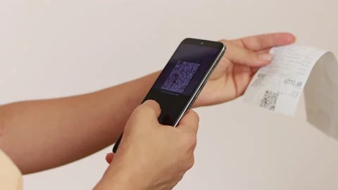 The girl scans the QR code on the sales receipt. Stock Footage 161084994