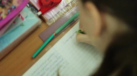 The girl in the school writes in a notebook during the lesson Russian language 库存影片 53751248