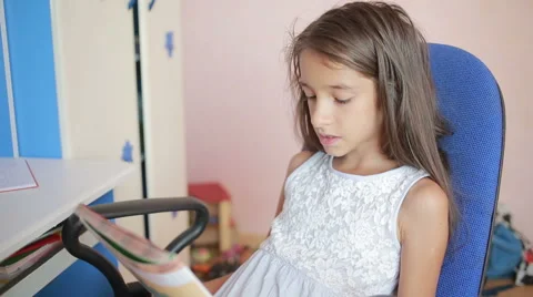 Girl schoolgirl doing homework. Girl learns lessons in the bedroom Stock Footage