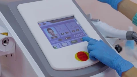 The girl selects the desired function on the laser and takes a maniple Stock Footage 81096937