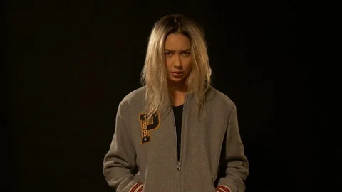 Girl with a serious look posing in studio Видео 72281455