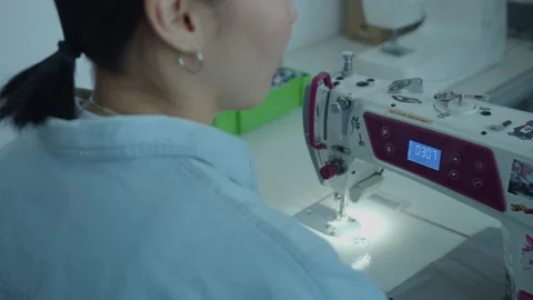 Girl serving a sewing machine Stock Footage 234874290