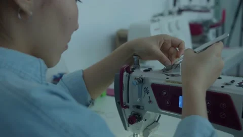 Girl serving a sewing machine Stock Footage 234874357