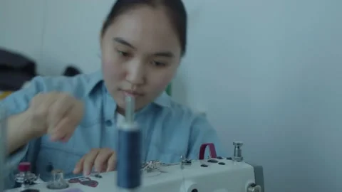 Girl serving a sewing machine Stock Footage 234874432