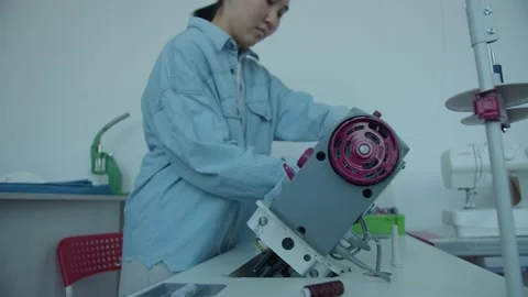 Girl serving a sewing machine Stock Footage 234874486