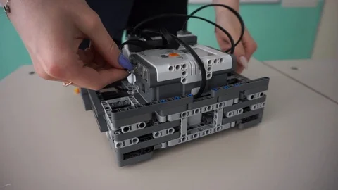 Girl sets up a robot Video stock 97535127