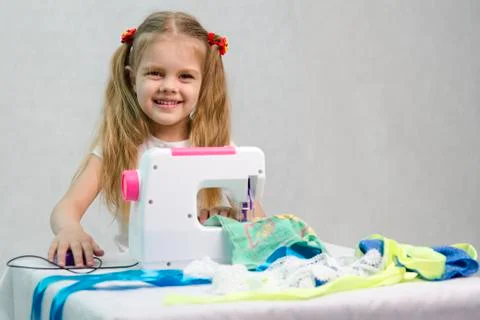 Girl sewing on the machine Stock Photos