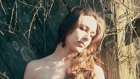 Girl in the shadow of spring branches 스톡 동영상 74359671