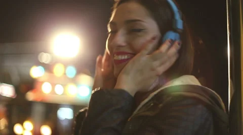 Girl shaking her head to the rhythm of music with headphones Stock Footage 59556140