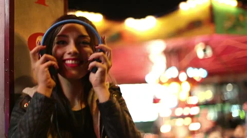 Girl shaking her head to the rhythm of music with headphones Stock Footage 59556152
