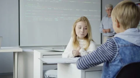 Girl sharing data with classmate during programming lesson Stock Footage 142493543