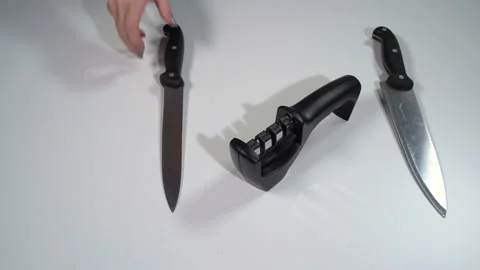A girl sharpens a knife with a sharpener Vídeo Stock 119549494