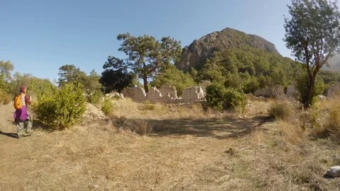 Girl is shooting at the camera two thousand-year-old city of Olympos Lycia, Stock Footage 81745234
