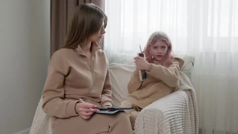 A girl showing a drawing while sitting with a mother. Stock Footage 263636595