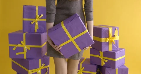 Girl is showing a gift package while standing her back side. Stock Footage 129154790