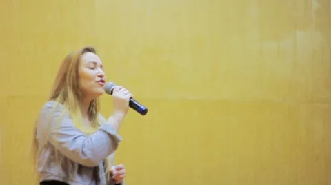Girl Singing Into a Microphone Stock Footage 62054783