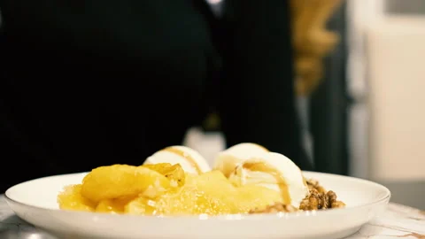 Girl sit down at the table with ice cream dessert Stock Footage 142690771