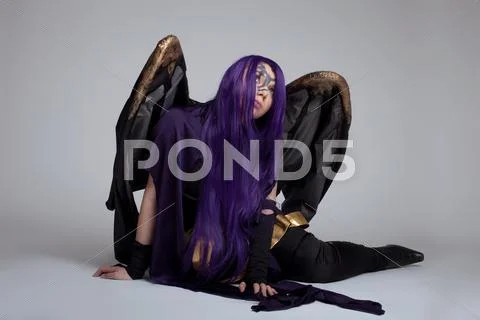 Girl sit in purple fury cosplay costume character Stock Photos