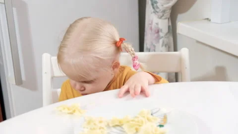 The girl sits and indulges while eating. Stock Footage 220136261