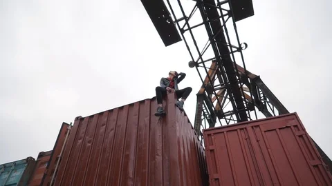 The girl sits on a freight container Stock Footage 91773295
