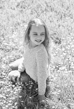 Girl sits on grass at grassplot, green background. Heyday concept. Girl on Stock Photos