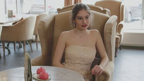 The girl sits at the table Stock Footage 73034280