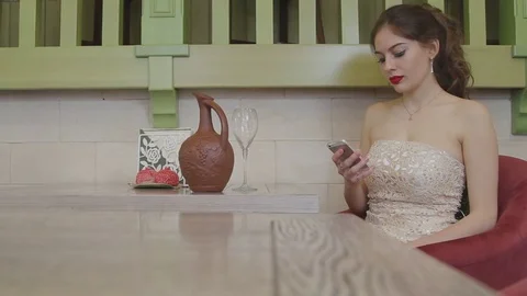 The girl sits at the table Stock Footage 73034318