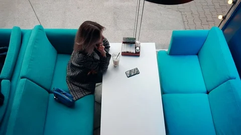 Girl sitting alone in a cafe Video stock 106949020
