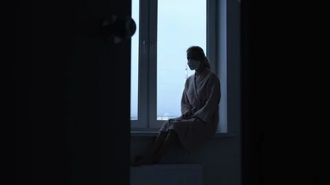 Girl sitting on the background of a window Видео 129652835